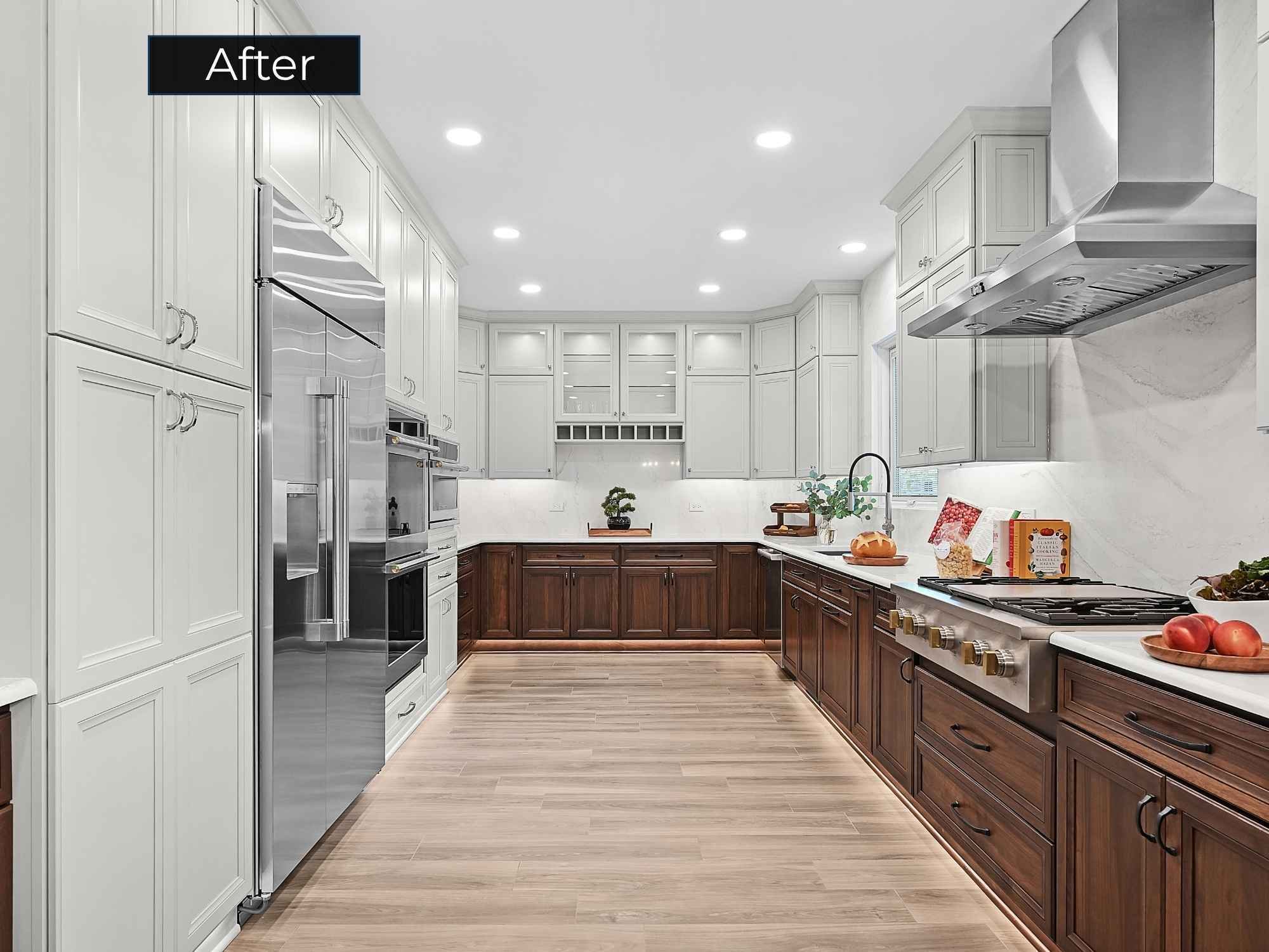 After photo of a kitchen remodel in Aurora, IL with two-tone stained walnut and white painted cabinets, high-end stainless steel appliances, and white Cambria qu
