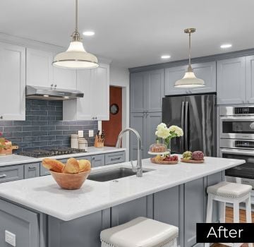 An image of a remodeled kitchen featuring quartz countertops and a custom sink island with seating in Naperville, IL by J&J Construction