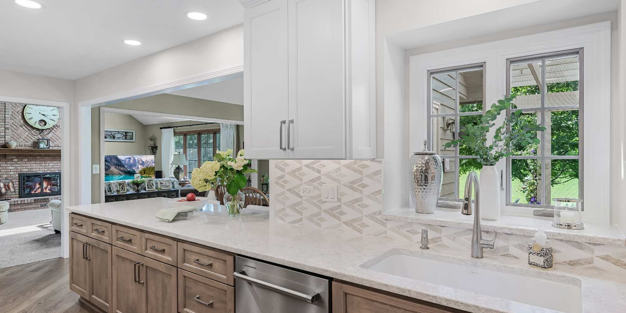 Bright kitchen remodel with large window and neutral tones by J&J Construction in Chicagoland