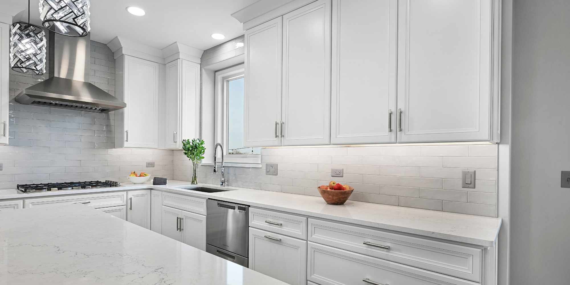Image of remodeled kitchen in Aurora, IL by J&J Construction with tile backsplash and custom cabinets