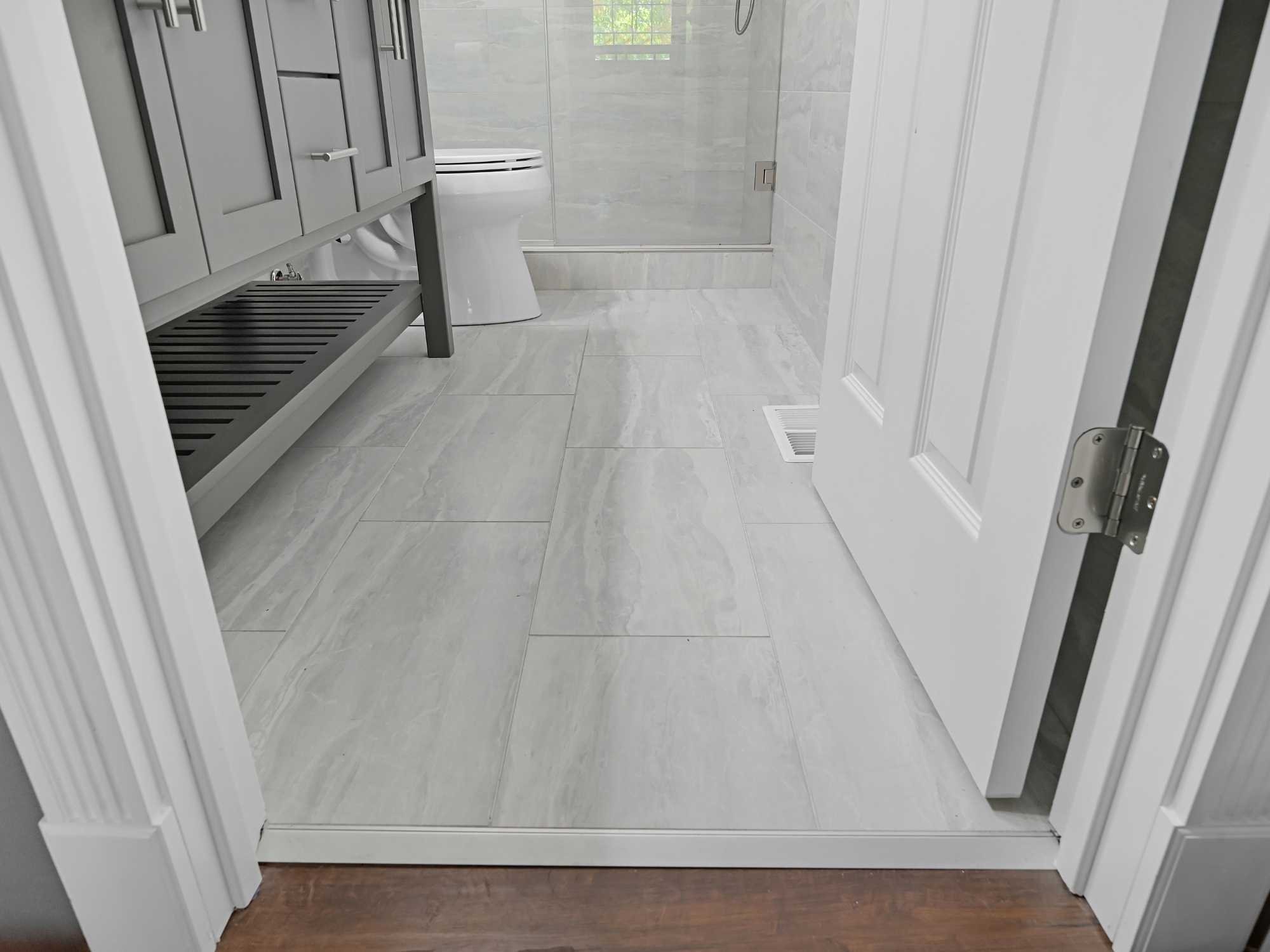 Image of a remodeled bathroom with Breccia white tile and Schluter trim in Chicagoland