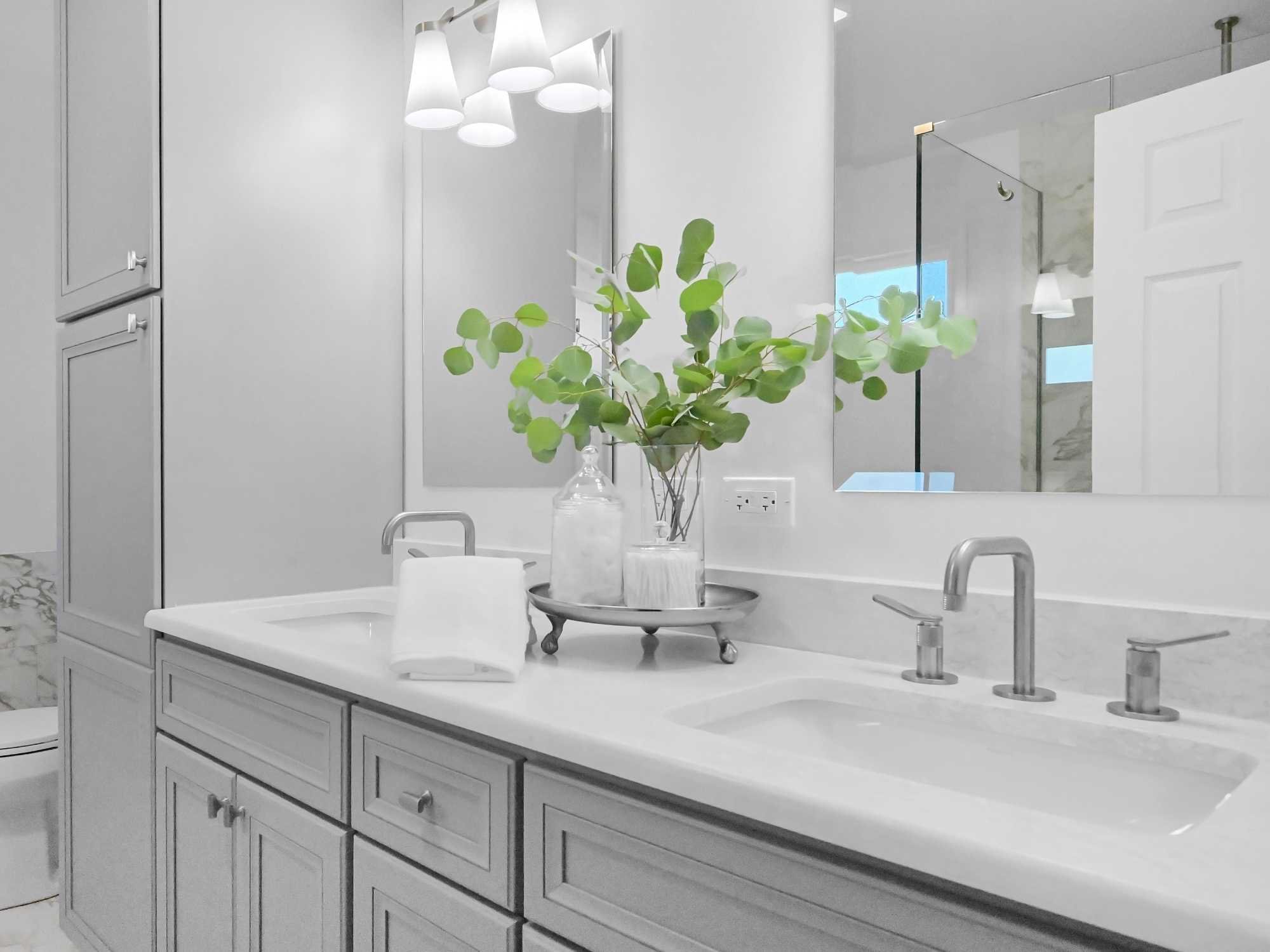Image of an expanded vanity with tall linen storage in a bathroom remodel by J&J Construction