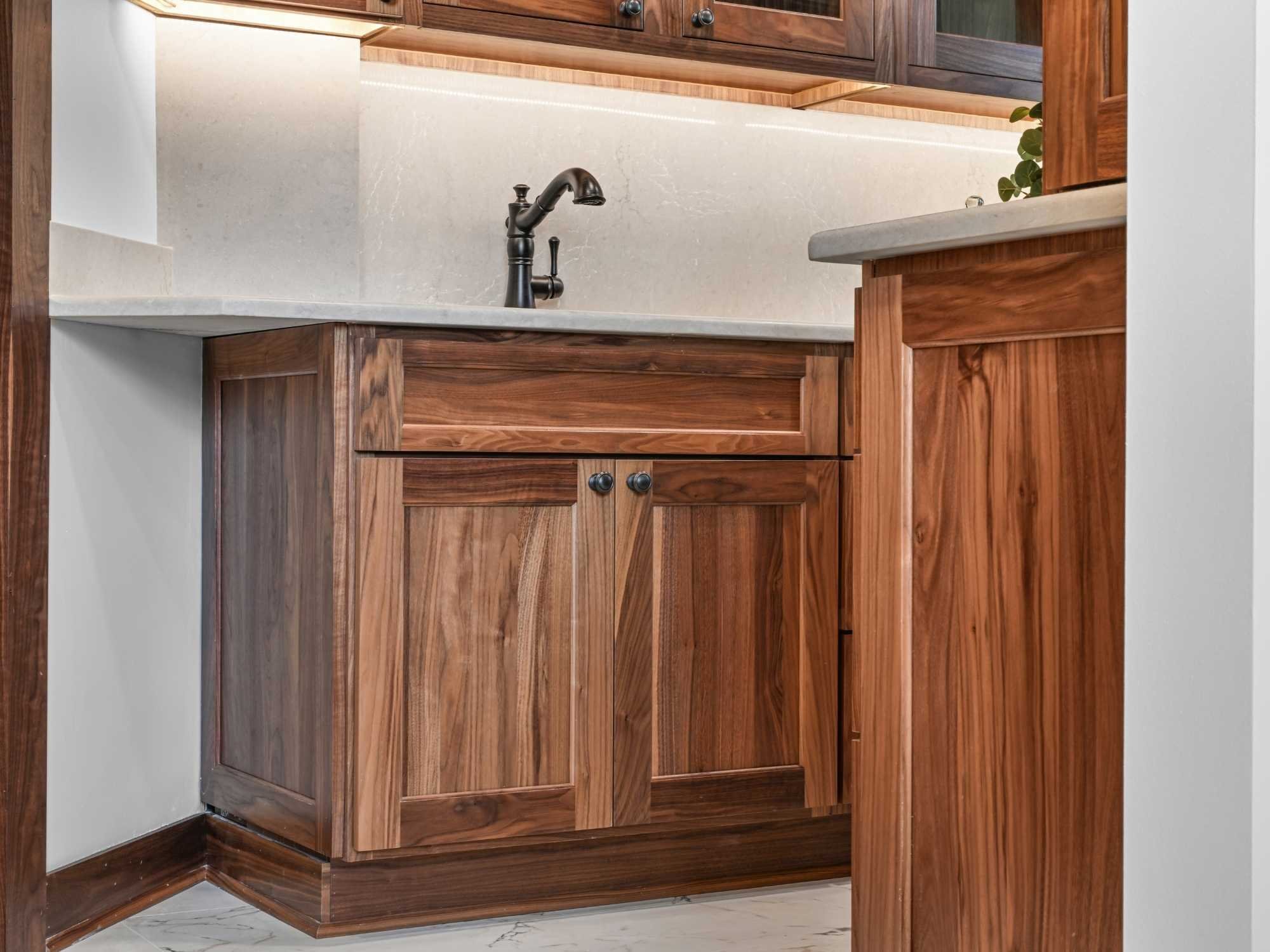 Image of the butlers pantry sink with kohler sink, bronze faucet, and bertch cabinets by J&J Construction in Wheaton, IL