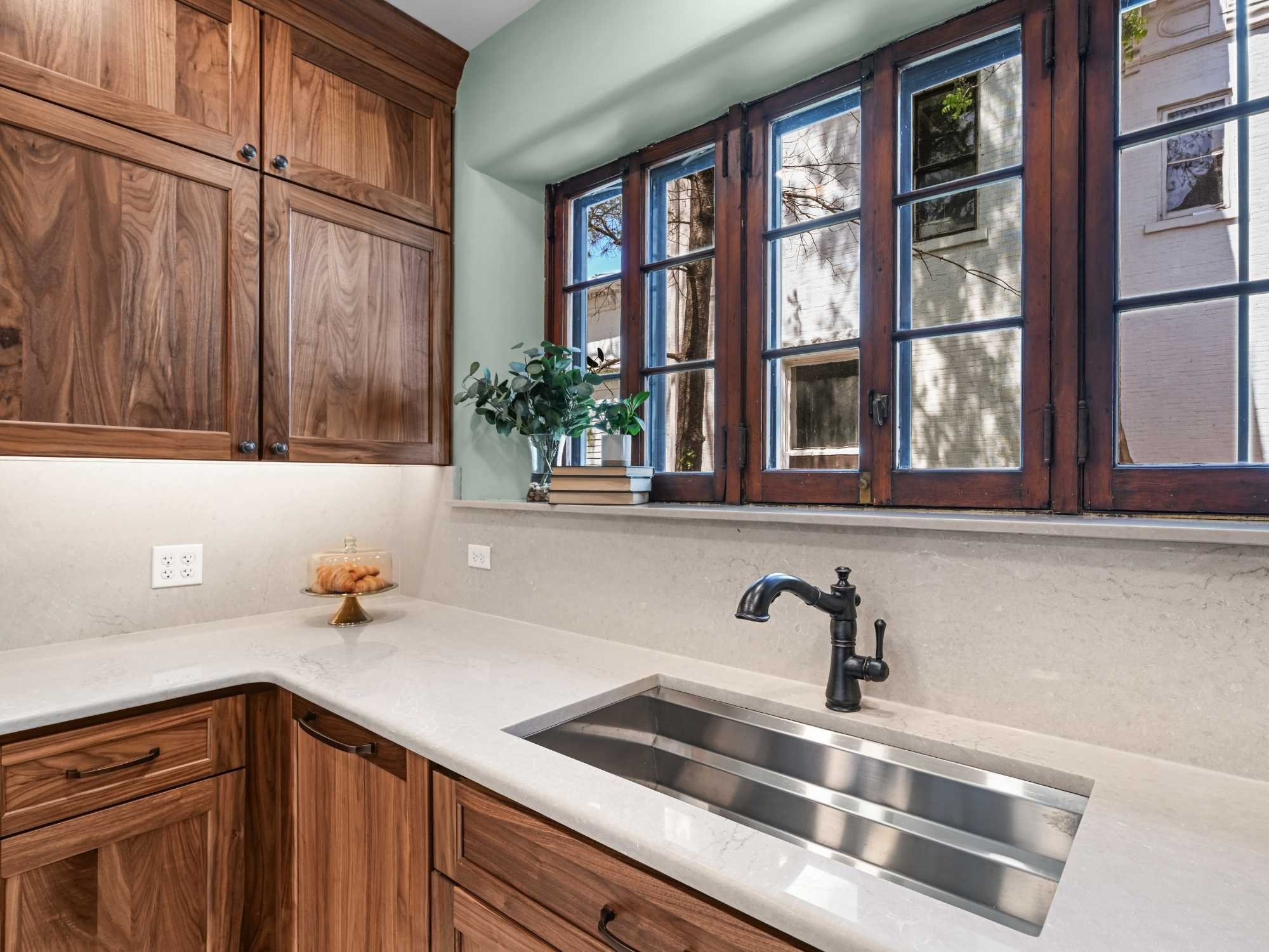 Image of the kitchen sink with kohler sink, bronze faucet, and bertch cabinets by J&J Construction in Wheaton, IL