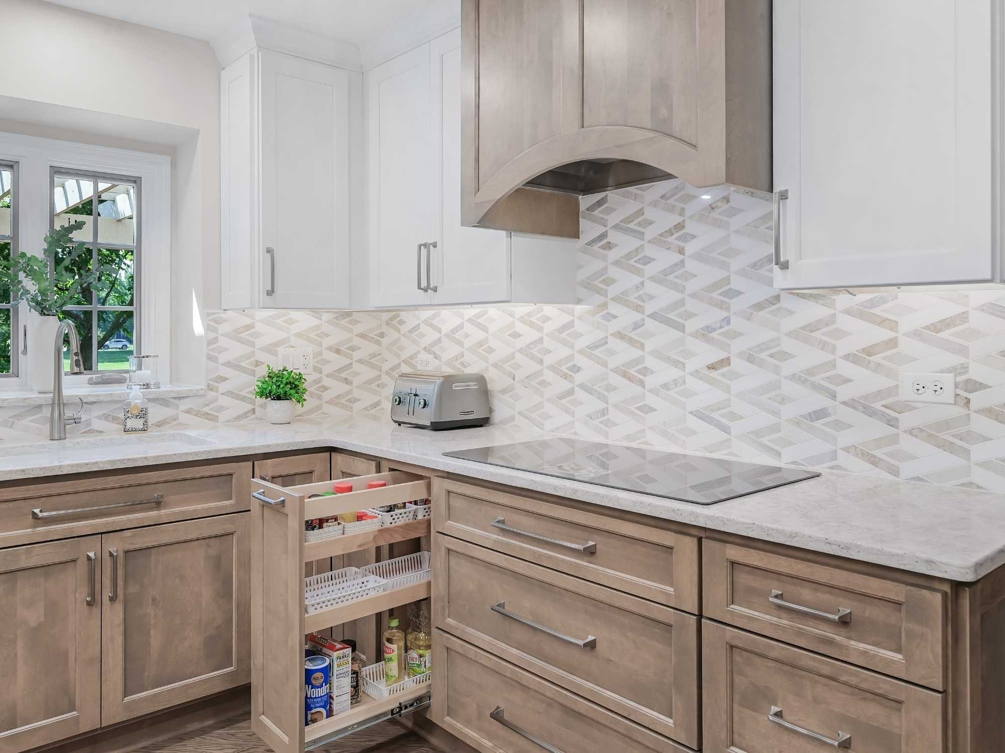 Image of kitchen remodel in Naperville, IL featuring corner storage, wood cabinets, cooktop and geometric backsplash by J and J Construction
