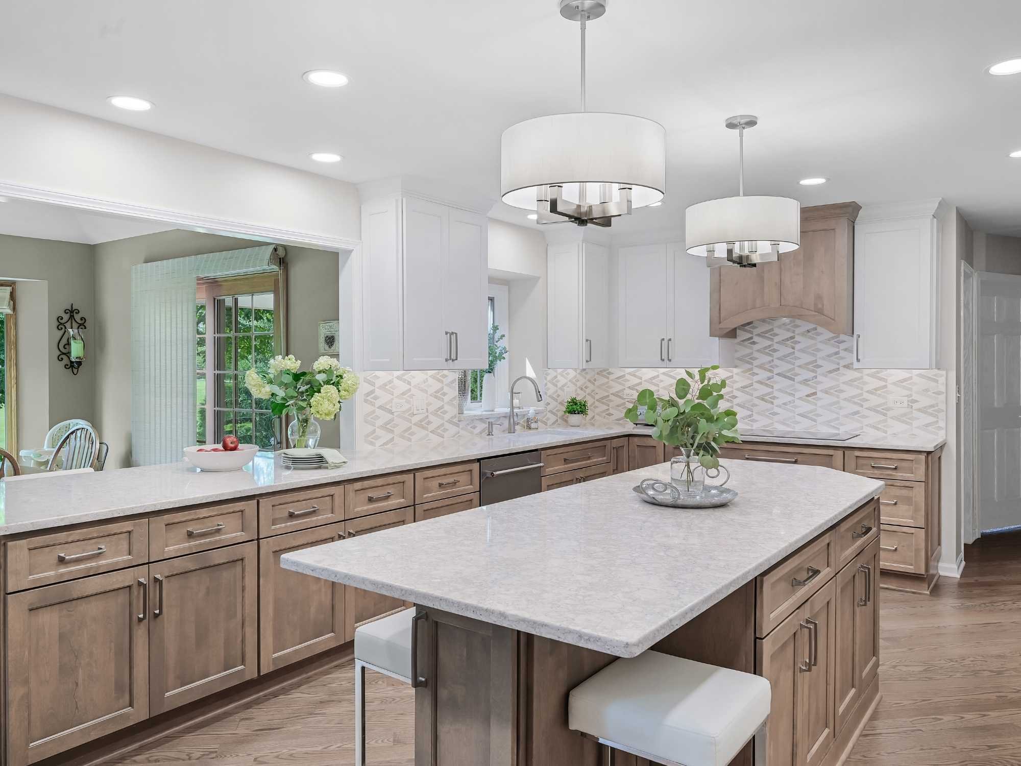 Image of kitchen remodel in Naperville, IL featuring shaker cabinets, large island seating and tile backsplash by J and J Construction