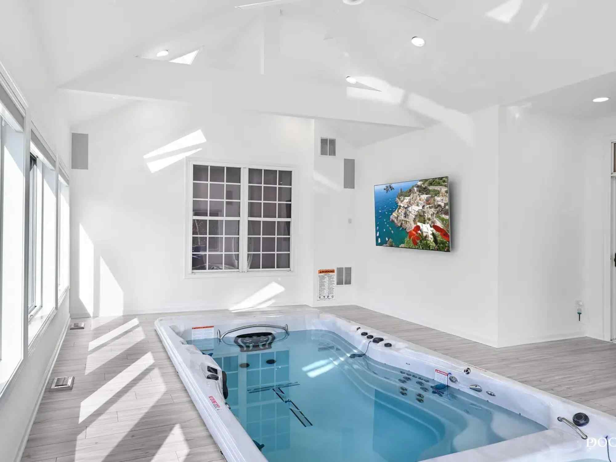 Photo of J&J Construction spa room addition in Plainfield IL with large windows, skylights, and indoor hot tub