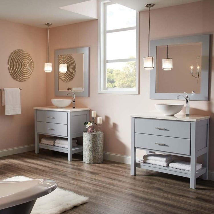 Warm tone bathroom with two vanities and soaking tub by J&J Construction