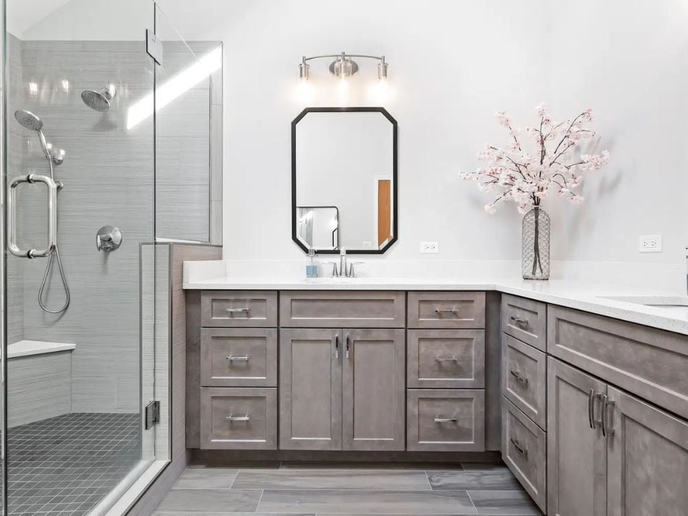 Aurora, IL bathroom remodel with glass shower and gray vanity by J&J Construction