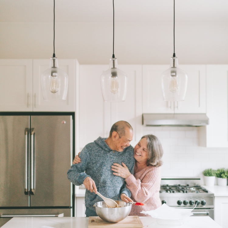 Elderly couple cooking in kitchen