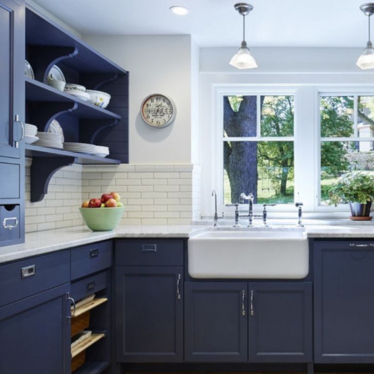 Navy and blue kitchen with brass accents and marble countertops by Case  Design/Remodeling i…